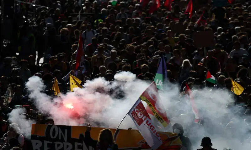 Protesters hold flares and labour union flags during a demonstration in Nantes as part of nationwide strikes on Thursday. – Reuters