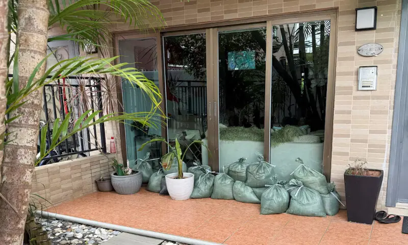 Sandbags block the doorway at a building to prevent flooding from Super Typhoon Ragasa in Lantau Island in Hong Kong on Tuesday. – Reuters