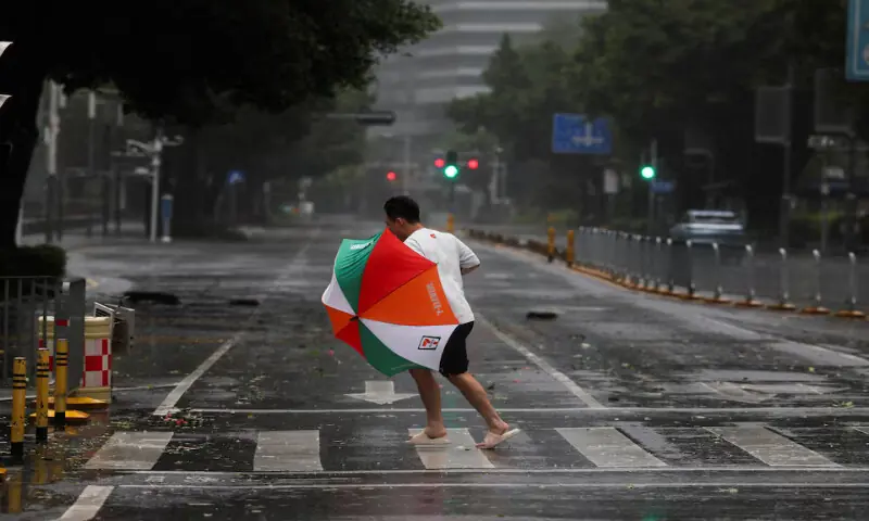 A person braves strong wind and rain as Super Typhoon Ragasa approaches in Shenzhen, Guangdong Province, China, on Wednesday. – Reuters