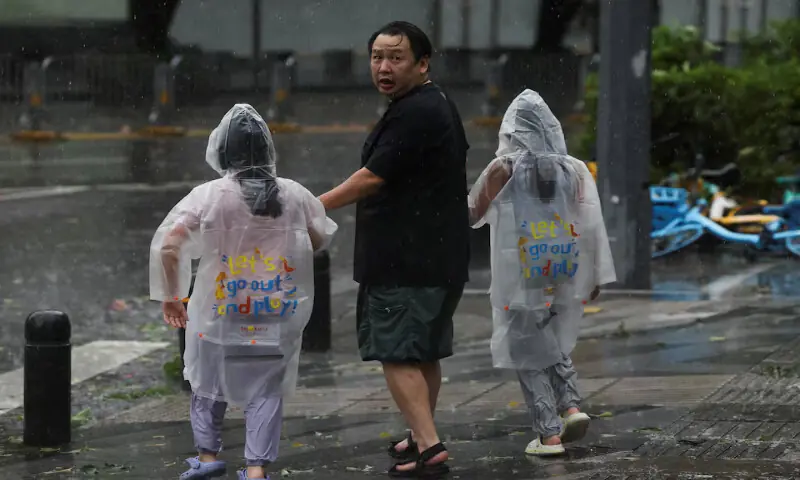People brave strong wind and rain as Super Typhoon Ragasa approaches Shenzhen, Guangdong Province, China, on Wednesday. – Reuters
