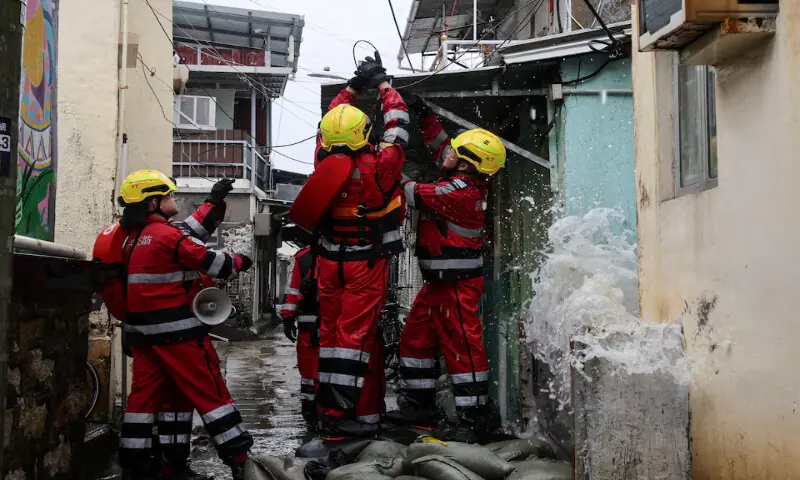 Firefighters secure a loose cable damaged by Super Typhoon Ragasa in Hong Kong, China. – Reuters