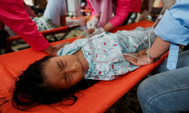 Selina Mikaila Apriyani, 11, reacts as she receives treatments for food poisoning at a makeshift clinic inside a district’s hall in Bandung, West Java province, Indonesia, on Thursday. – Reuters