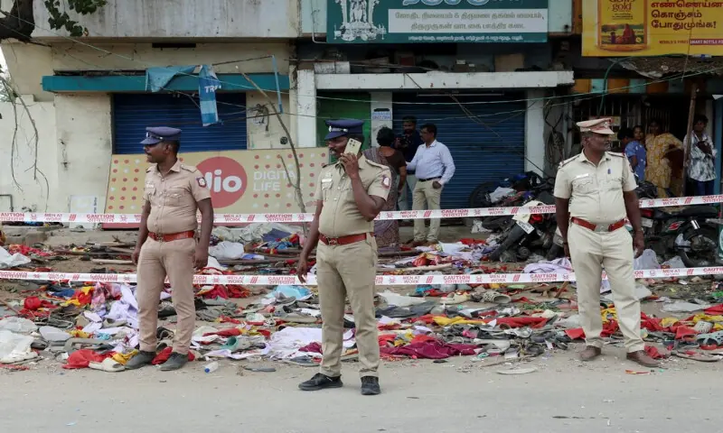 Police officers stand guard at the site of a stampede in Karur district of Tamil Nadu, India, on Sunday. – Reuters