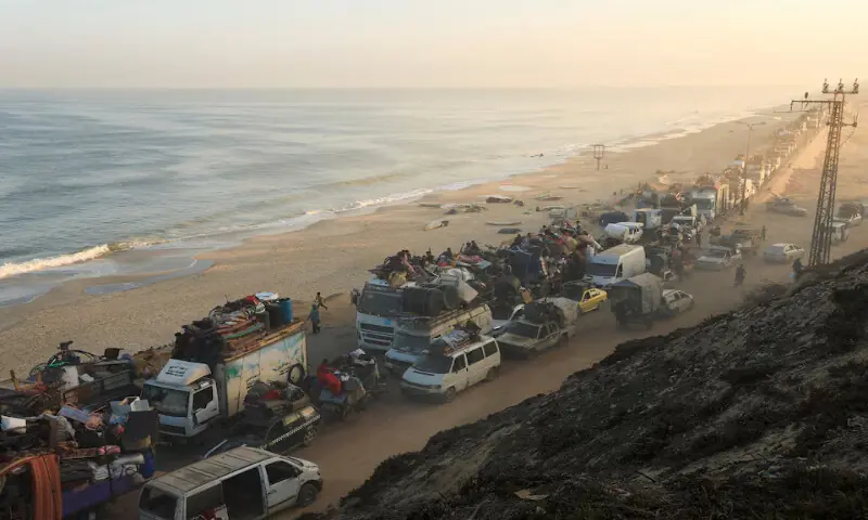 Displaced Palestinians, fleeing northern Gaza due to an Israeli military operation, move southward in the central Gaza Strip. – Reuters