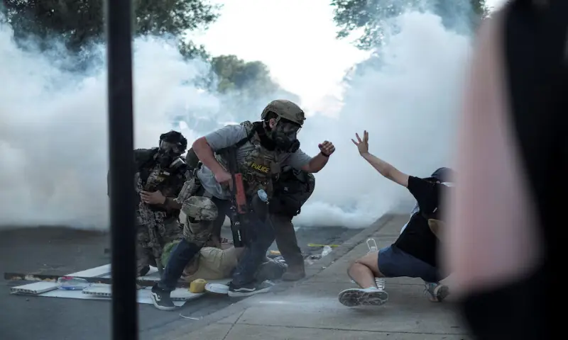 A law enforcement officer confronts a demonstrator as another one is detained during a standoff with US Immigration and Customs Enforcement and federal officers in the Little Village neighbourhood of Chicago, Illinois. – Reuters