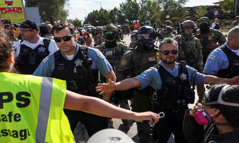 Law enforcement officers confront demonstrators during a standoff in the Little Village neighbourhood of Chicago, Illinois. – Reuters