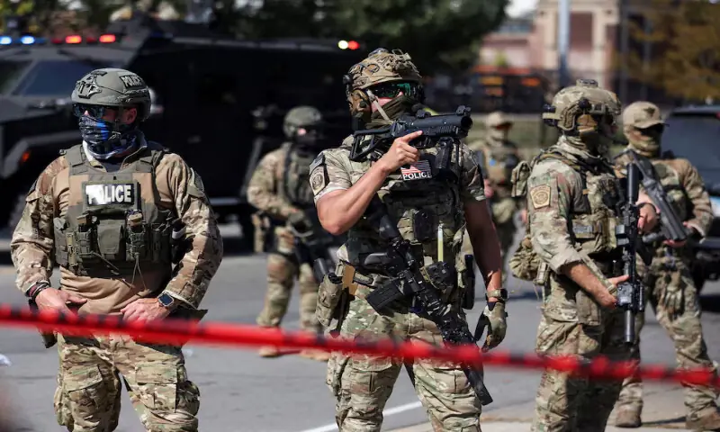 Law enforcement officers during a standoff in the Little Village neighbourhood of Chicago, Illinois. – Reuters