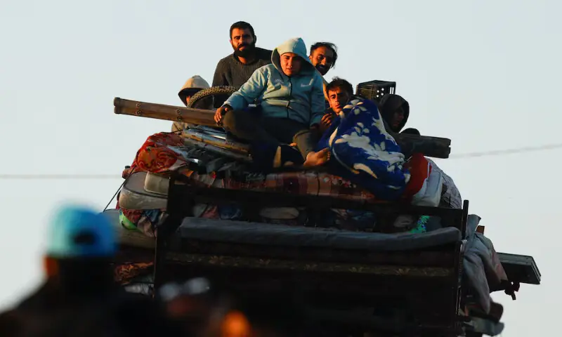 Palestinians, who were displaced to the southern part of Gaza, make their way along a road as they return to the north in the central Gaza Strip. – Reuters