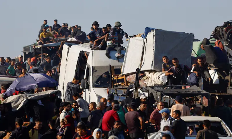 Palestinians make their way along a road as they return to the north in the central Gaza Strip. – Reuters