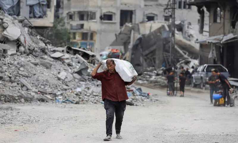 A Palestinian man walks past rubble following the withdrawal of the Israeli forces in Gaza City on Sunday. – Reuters