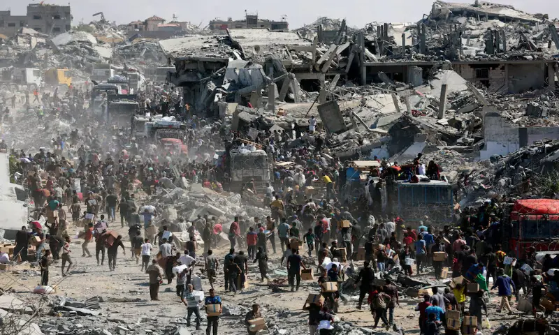 Palestinians collect aid supplies from trucks that entered Gaza in Khan Younis on Sunday. – Reuters