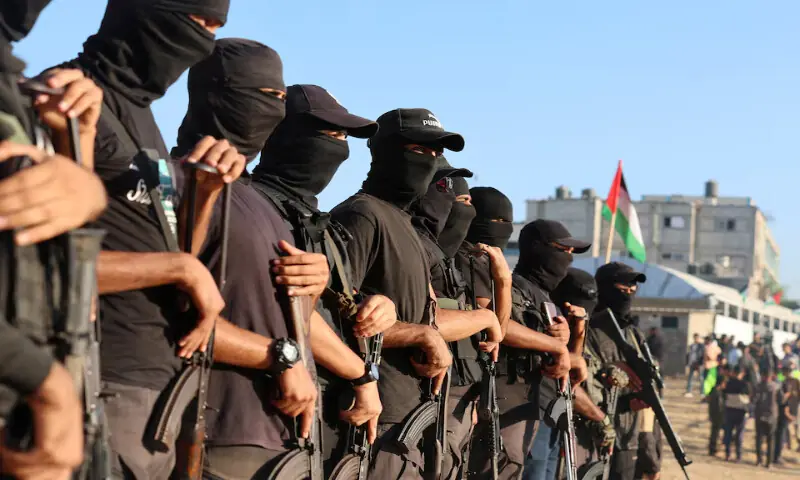 Palestinians stand guard on the day that hostages are handed over to the International Committee of the Red Cross in Khan Younis, southern Gaza Strip, on Monday. – Reuters