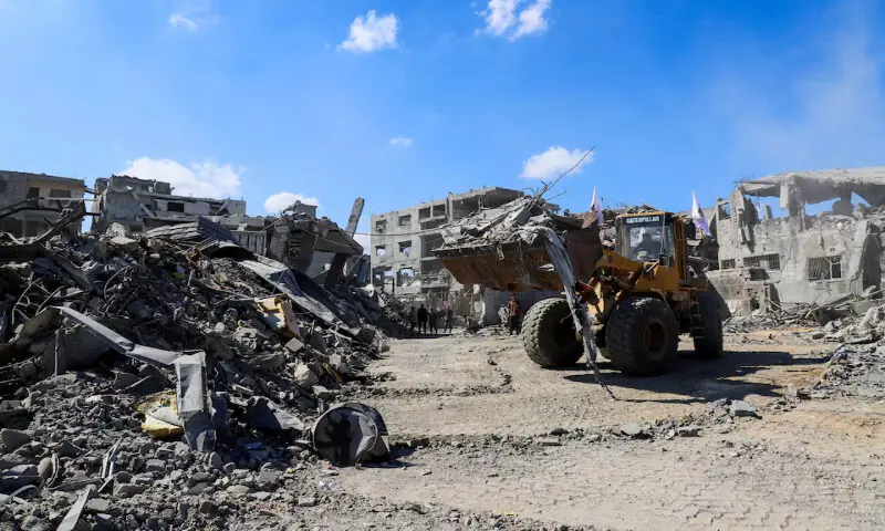 Heavy machinery removes debris from a street in Gaza City on Monday. – Reuters
