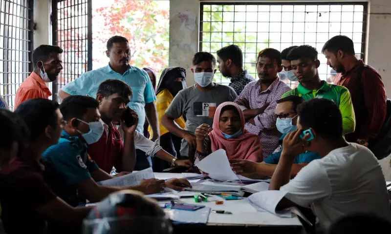 People complete paperwork as they come to receive deceased relatives’ bodies from the Dhaka Medical College Hospital morgue in Dhaka, Bangladesh, on Wednesday. – Reuters