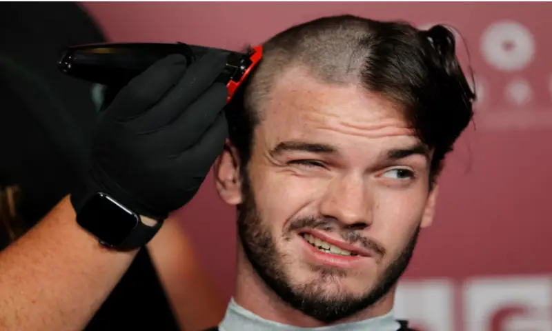 A fan gets his head shaved for a free preview of Yorgos Lanthimos’s new film ‘Bugonia’, in Culver City, California, on October 20, 2025. Reuters