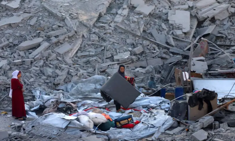 Palestinians inspect the site of an overnight Israeli strike on a house in Nuseirat, central Gaza Strip, on October 29, 2025. Reuters