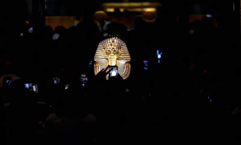Visitors take photos of the golden burial mask of Egyptian Pharaoh Tutankhamun. – Reuters