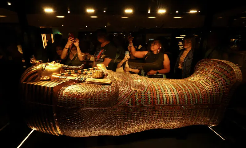 Visitors look at the golden coffin of ancient Egyptian Pharaoh Tutankhamun. – Reuters
