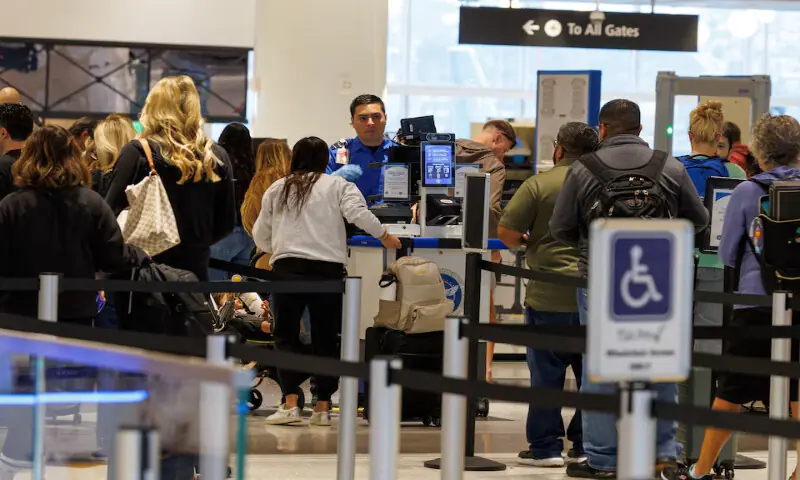 A TSA agent checks travellers at San Diego International Airport. – Reuters