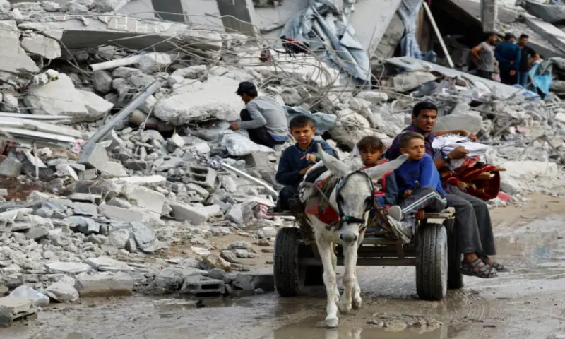 Palestinians ride on a donkey-drawn cart amid the rubble of destroyed buildings, during a ceasefire between Israel and Hamas, in Jabalia, northern Gaza Strip, on November 4, 2025. Reuters file