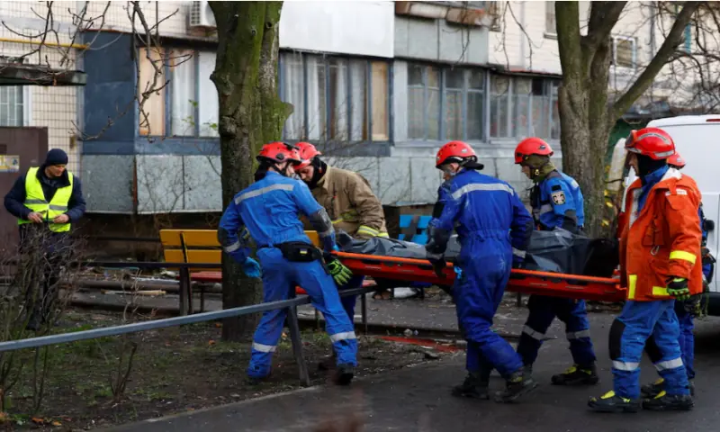 Rescuers carry the body of a victim found under debris at the site of an apartment building hit during an overnight Russian drone and missile strike, amid Russia’s attack on Ukraine, in Kyiv, on November 14, 2025. Reuters