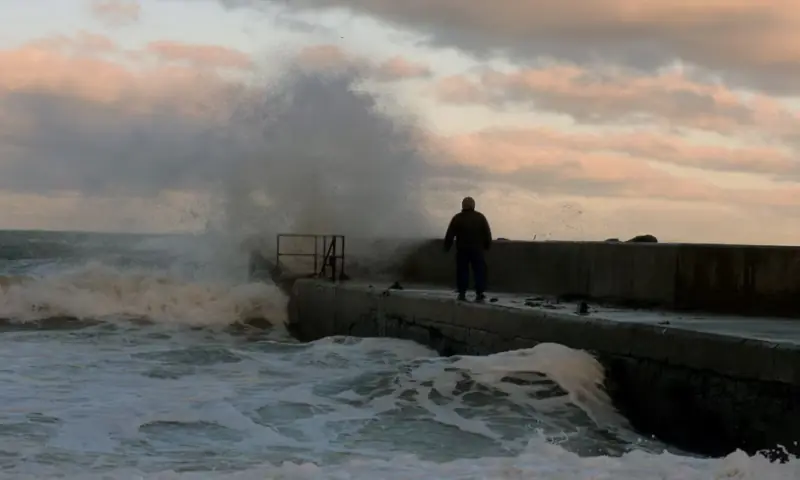 Waves crash on a pier in the coastal village of Cushendall, Northern Ireland as Storm Claudia reaches parts of the United Kingdom, on November 14, 2025. Reuters