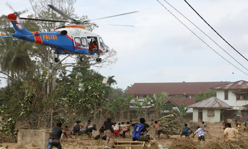 A police helicopter delivers relief supplies for survivors in an area affected by a deadly flash flood in Karang Baru, Aceh Tamiang regency, Aceh province, Indonesia. – Reuters