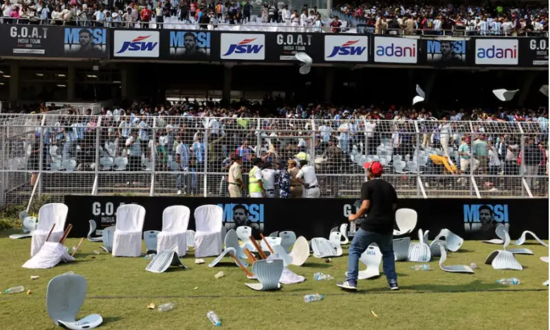 Plastic water bottles and chairs are seen scattered on the field after Argentine soccer star Lionel Messi leaves the stadium on December 13, 2025. Reuters