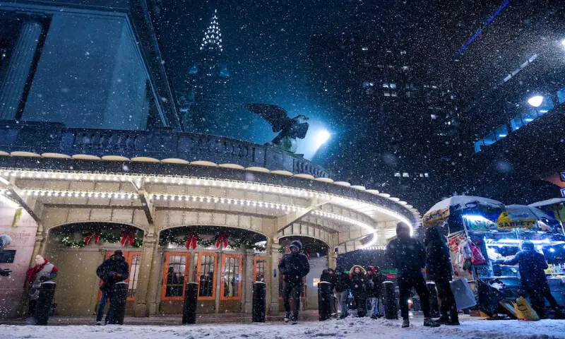 People walk outside of Grand Central Station as snow falls during a winter storm in New York City. &ndash; Reuters