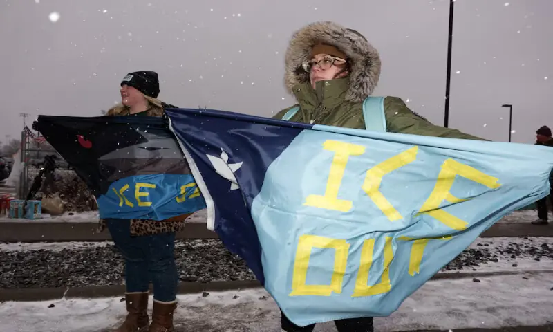 A demonstrator holds a Minnesota state flag with the words, &ldquo;ICE Out&rdquo;, during a protest outside the Bishop Henry Whipple Federal Building in Minneapolis, Minnesota. &ndash; Reuters