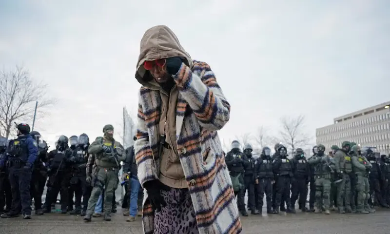 A woman reacts after being struck by pepper balls during a protest in Minneapolis, Minnesota, US. &ndash; Reuters