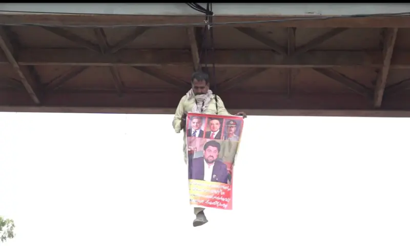 Man rescued after hanging from Karachi bridge in dramatic protest