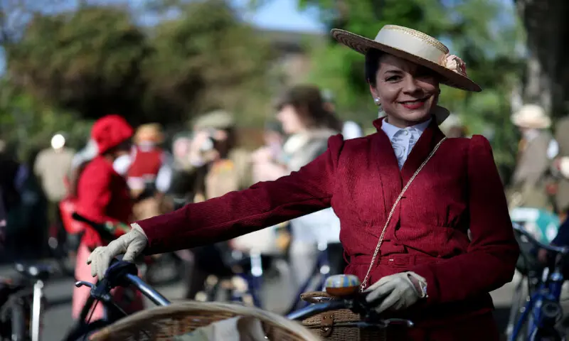 A woman waits with her bicycle before the start of the annual Tweed Run across London, Britain. &ndash; Reuters