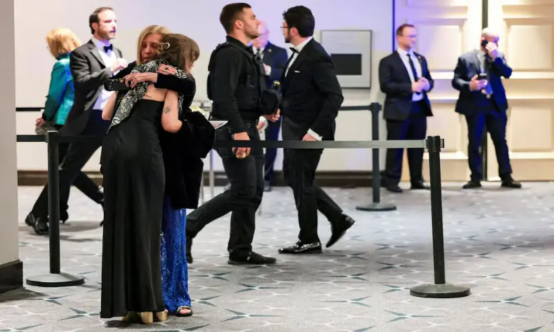People embrace following a shooting incident during the annual White House Correspondents&rsquo; Association dinner in Washington, DC. &ndash; Reuters