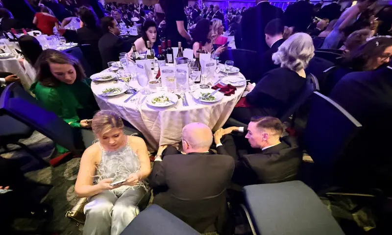 Guests take cover behind a table after after a loud, unidentified noise. &ndash; Reuters