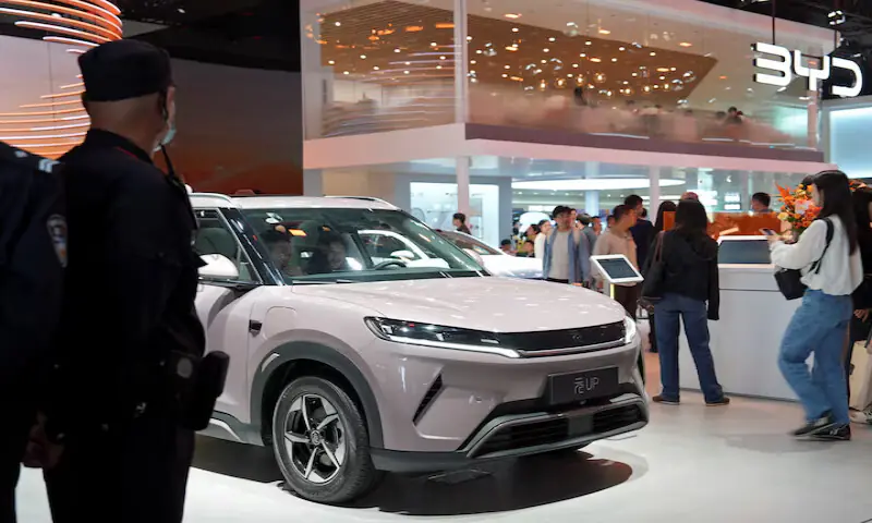 Visitors check a BYD Yuan UP electric vehicle displayed at the Beijing auto show. &ndash; Reuters