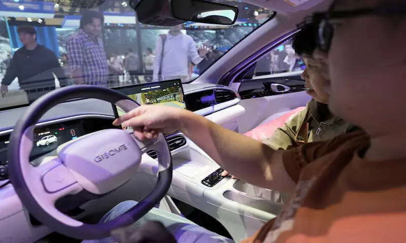 Visitors check the interior of a Geely GEOME Xingyuan electric vehicle, also known as Geely EX2, displayed at the Beijing automotive exhibition. &ndash; Reuters
