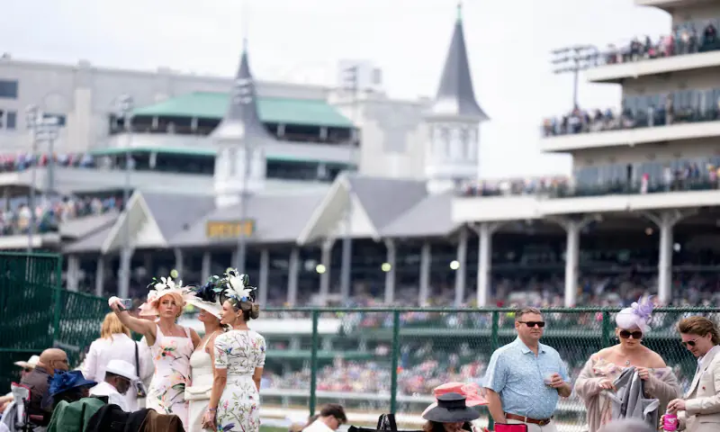 Theresa Dawes, Nicole Scotto and Nicole Powell pose for a picture in their derby attire during the 152nd running of the Kentucky Derby at Churchill Downs. &ndash; Reuters