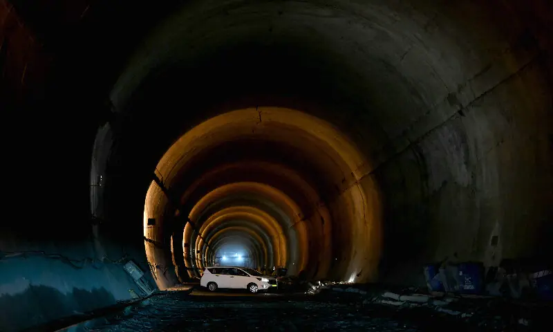 A vehicle rides past a construction site near the Zojila tunnel. AFP