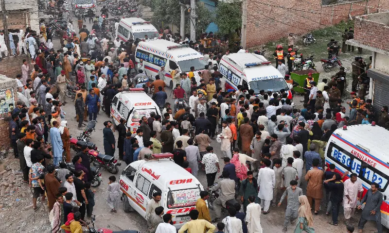  Local people and a rescue ambulance parked at the site where children reportedly died after a tuition centre roof collapsed, in Lahore, Pakistan, on June 30, 2026. Reuters 