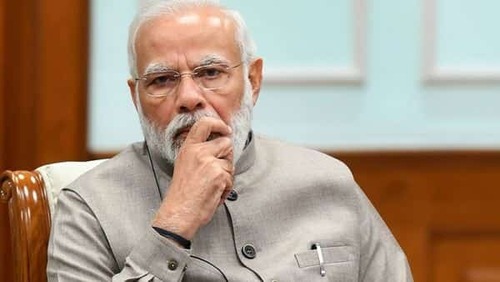Indian man fined for wanting Modi's face cut from vaccine drive