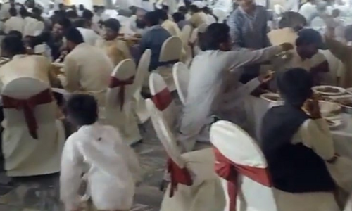 Revolting: Wedding guests enjoy food next to murdered man's body