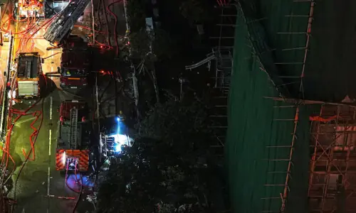 Anger rises in Hong Kong as deadly high-rise fire sparks petitions and arrests
