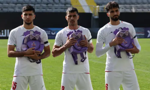 Iranian soccer players hold schoolbags in solidarity with slain girls