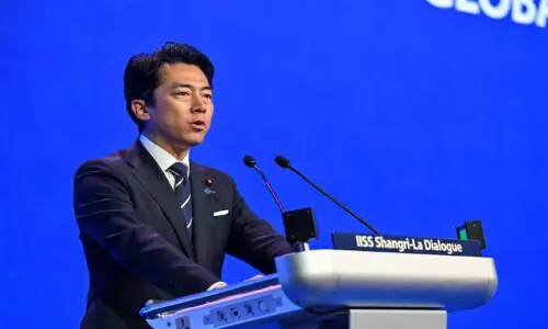 Japan rejects 'new militarism' label, accuses China of rapidly arming