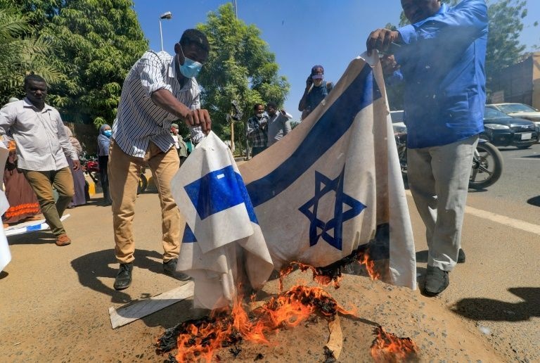 Sudan protesters burn Israeli flag in rally against normalisation deal