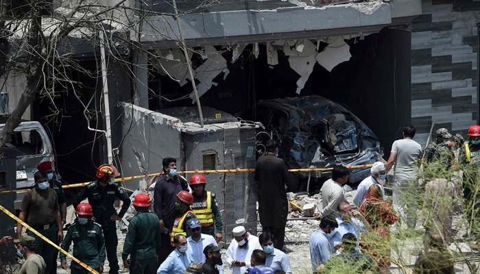 Rescue officials conduct their investigations at the site of Wednesday's blast in Johar Town, Lahore.