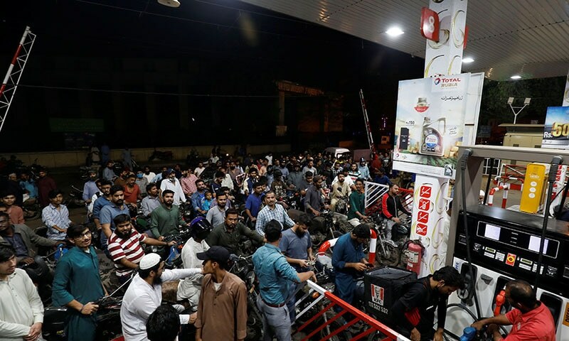 Pictures of people queued with their vehicles at fuel pumps went viral on social media. Reuters