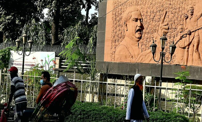 A rickshaw puller pedals past a mural of Bangladesh&rsquo;s founder Sheikh Mujibur Rahman in Dhaka yesterday. AFP Photo
