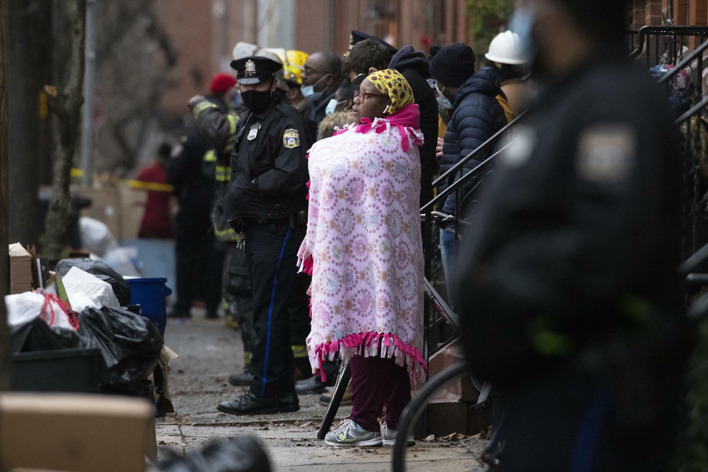 Bystanders watch as the Philadelphia fire department works at the scene of a deadly row house fire in Philadelphia on Wednesday, Jan. 5, 2022. Source: AP Bystanders watch as the Philadelphia fire department works at the scene of a deadly row house fire in Philadelphia on Wednesday, Jan. 5, 2022. Source: AP